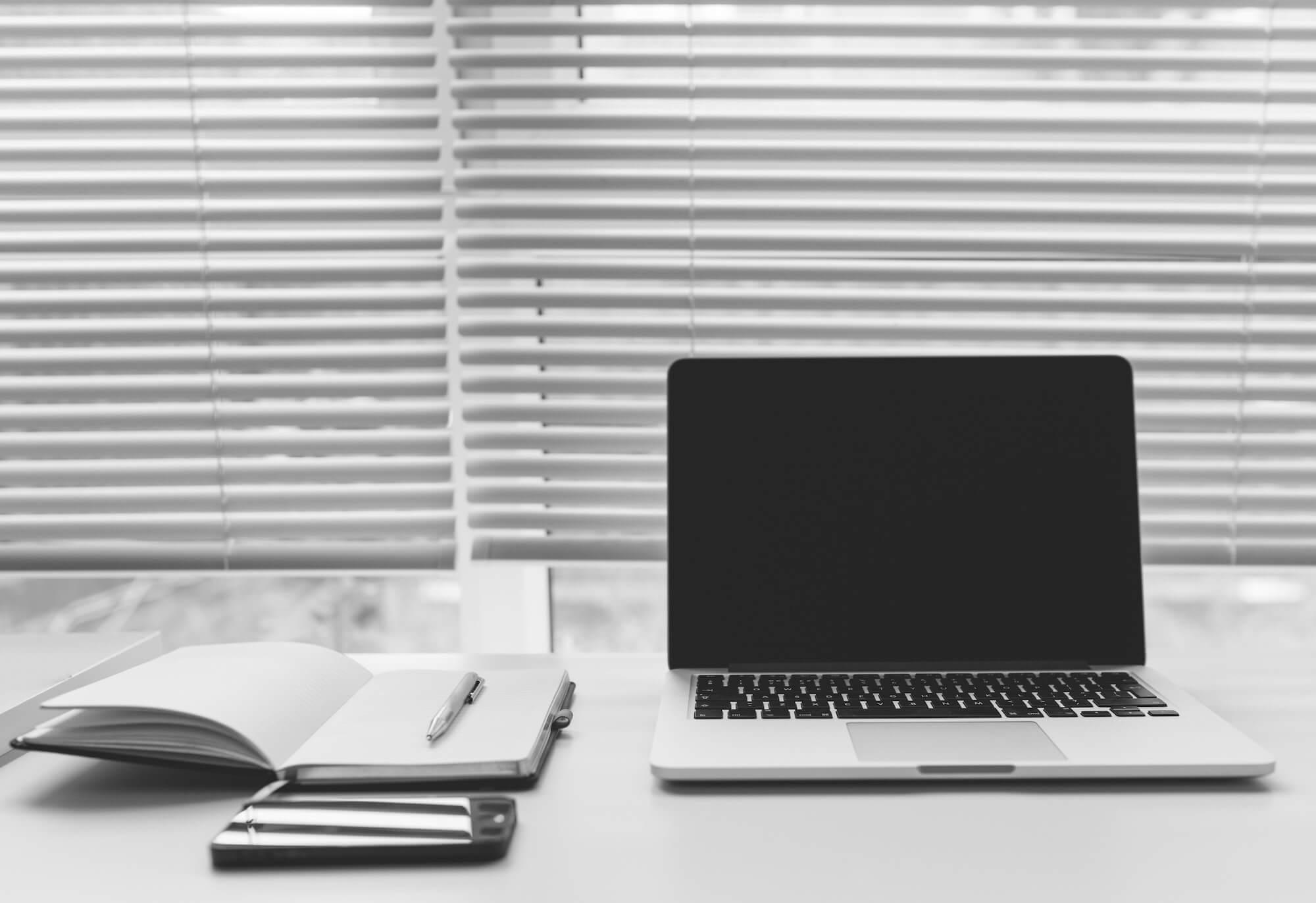 Laptop and notepad on a desk